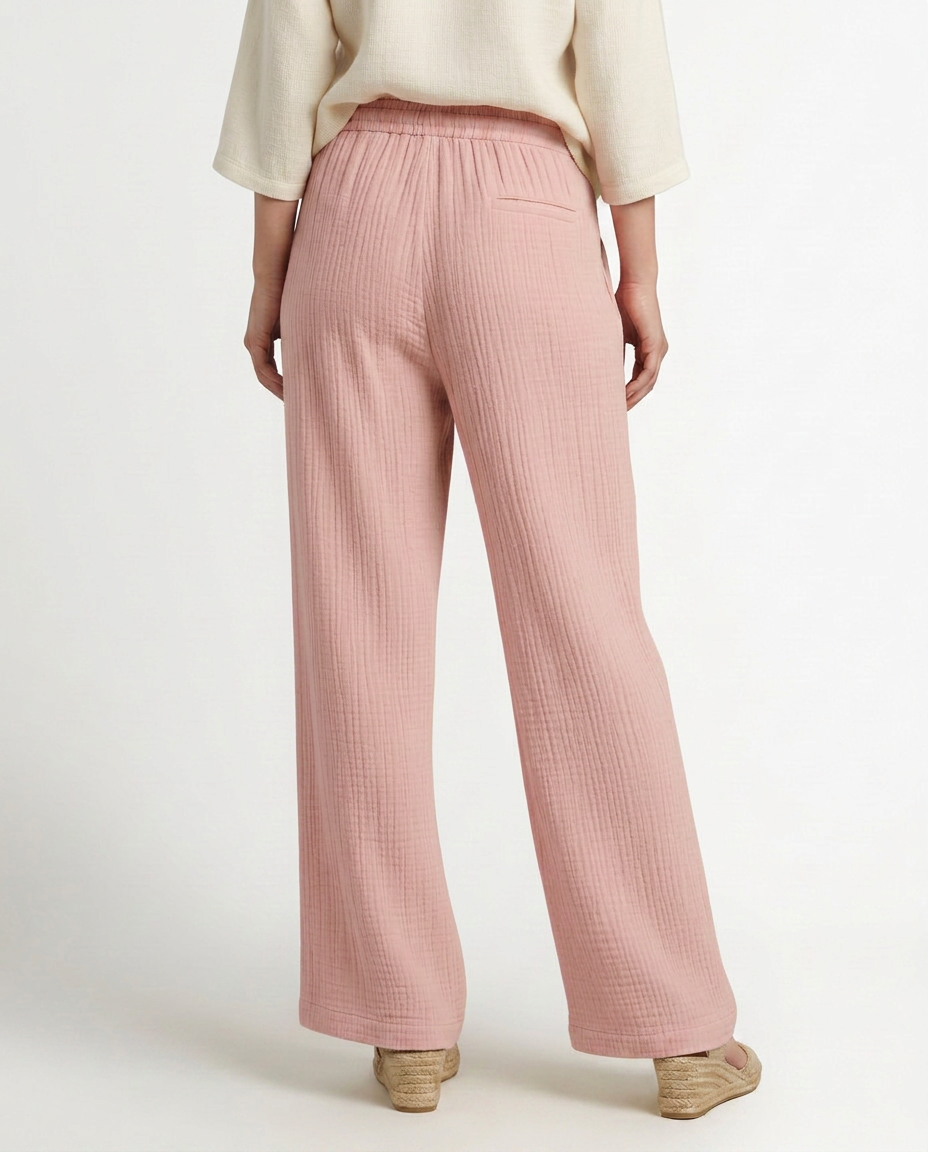 Soft pink wide-leg trousers with elastic waist and drawstring, relaxed straight legs