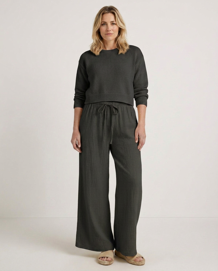 Wide-leg trousers with elastic waist and drawstring, dark gray fabric.