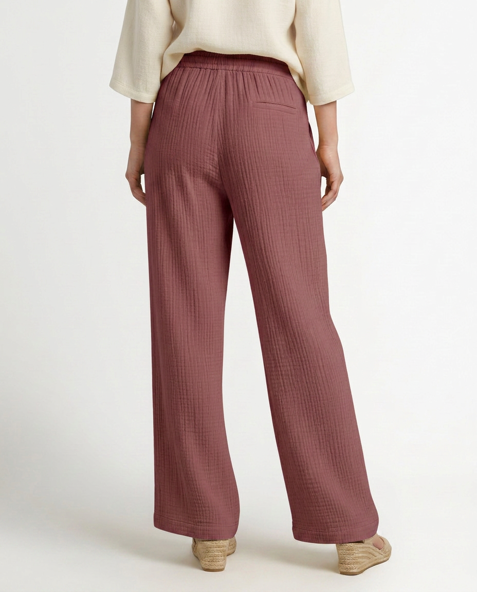 Wide-leg trousers with elastic waist and drawstring, dusty rose textured fabric.