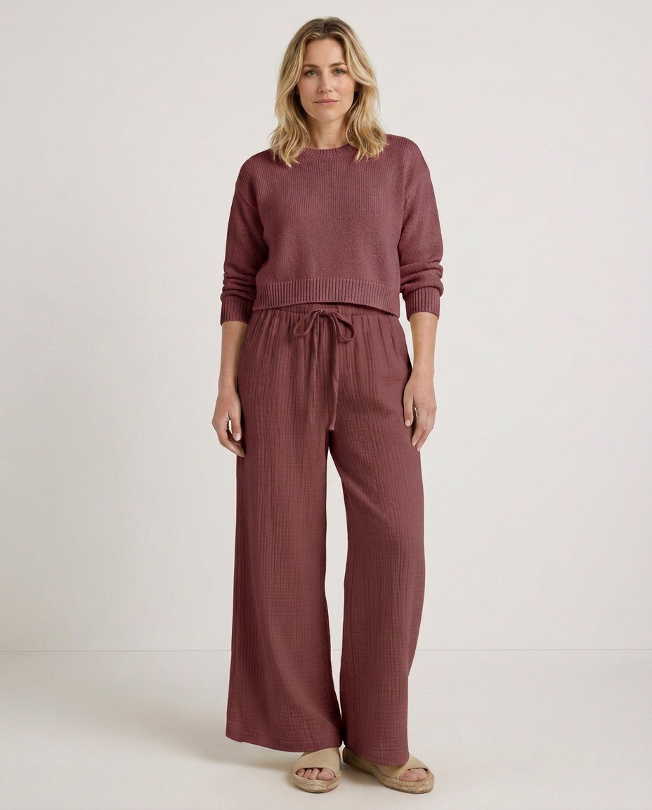 Wide-leg trousers with elastic waist and drawstring, burgundy textured fabric, front view.