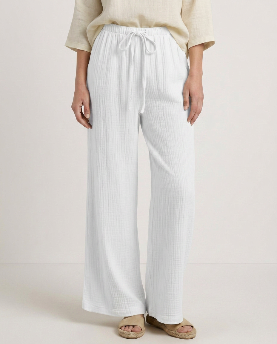 Wide-leg trousers with elastic waist and drawstring, white textured fabric, front view.