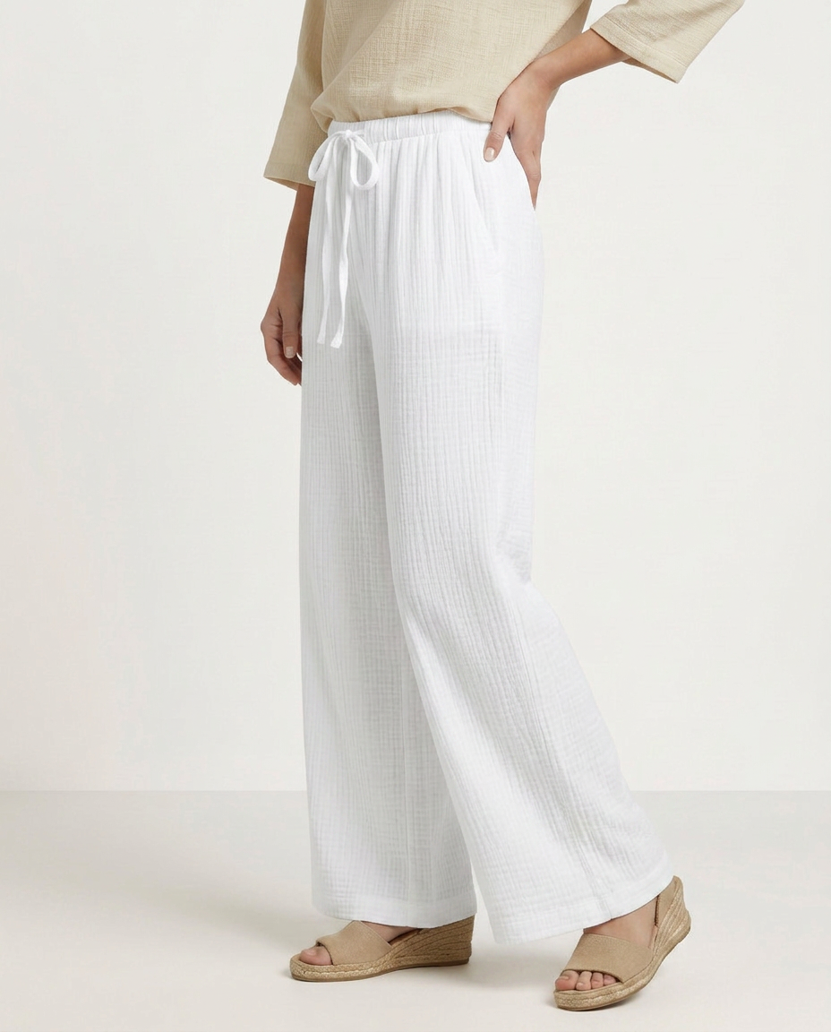 White wide-leg trousers with elastic waist and drawstring, flowing wide legs