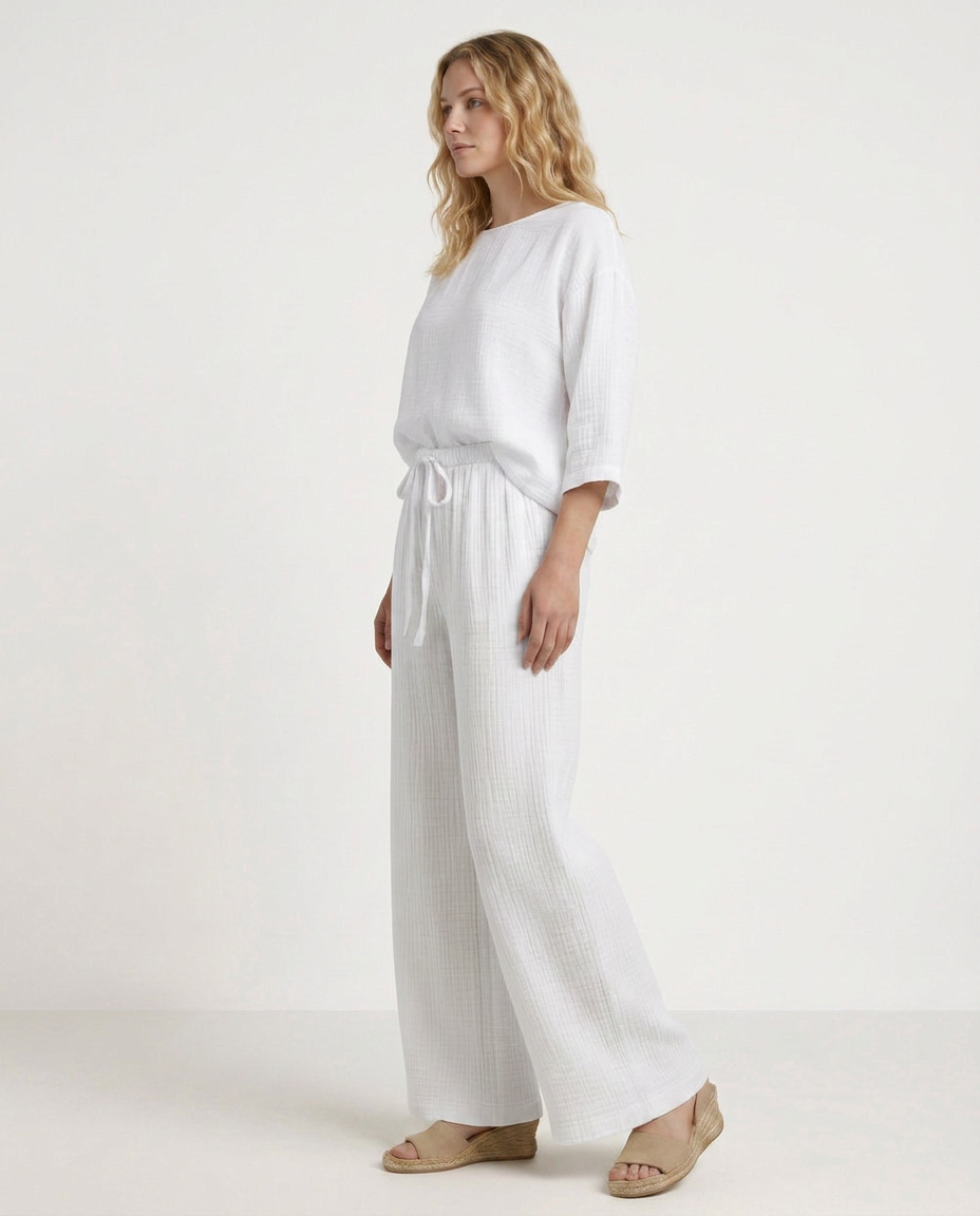 White wide-leg trousers with elastic waist and drawstring, relaxed drape
