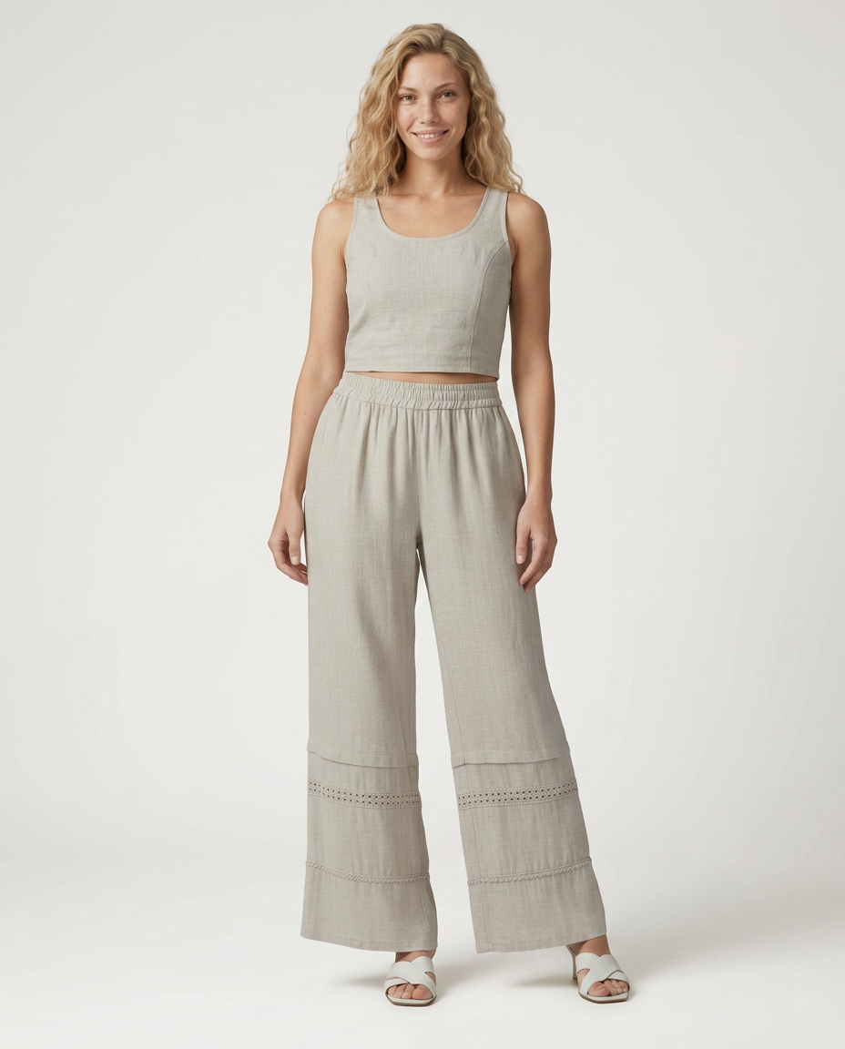 Beige wide leg trousers with elastic waist and lace-trimmed panel hems, full length