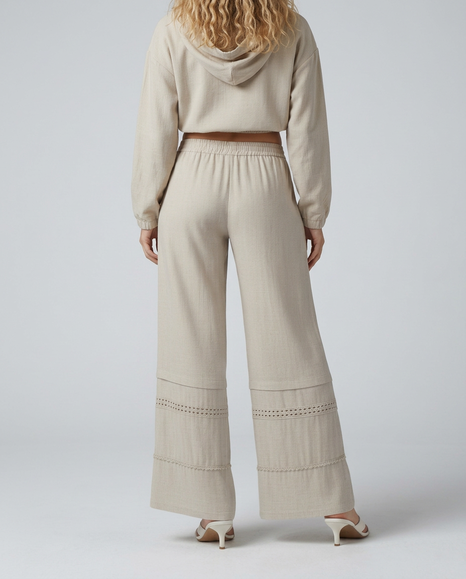 Beige wide leg trousers with elastic waistband and lace-trimmed tiered hem panels