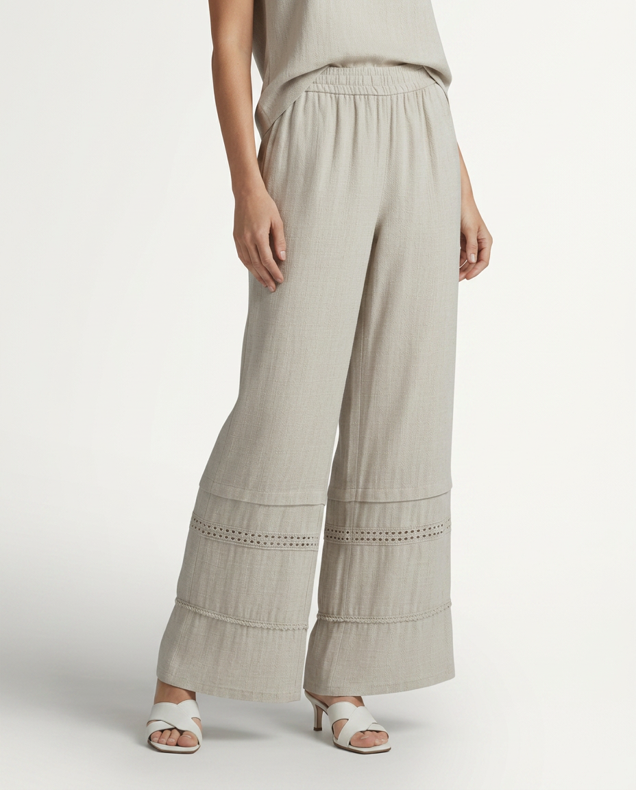 Beige wide leg trousers with lace-trimmed hem panels and relaxed straight legs