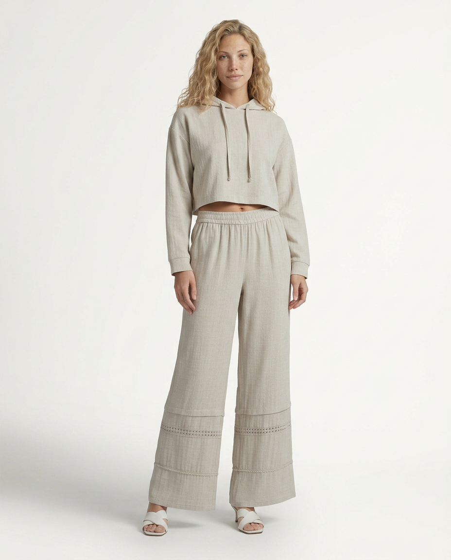 Beige wide leg trousers with lace-trimmed panels and gathered elastic waistband