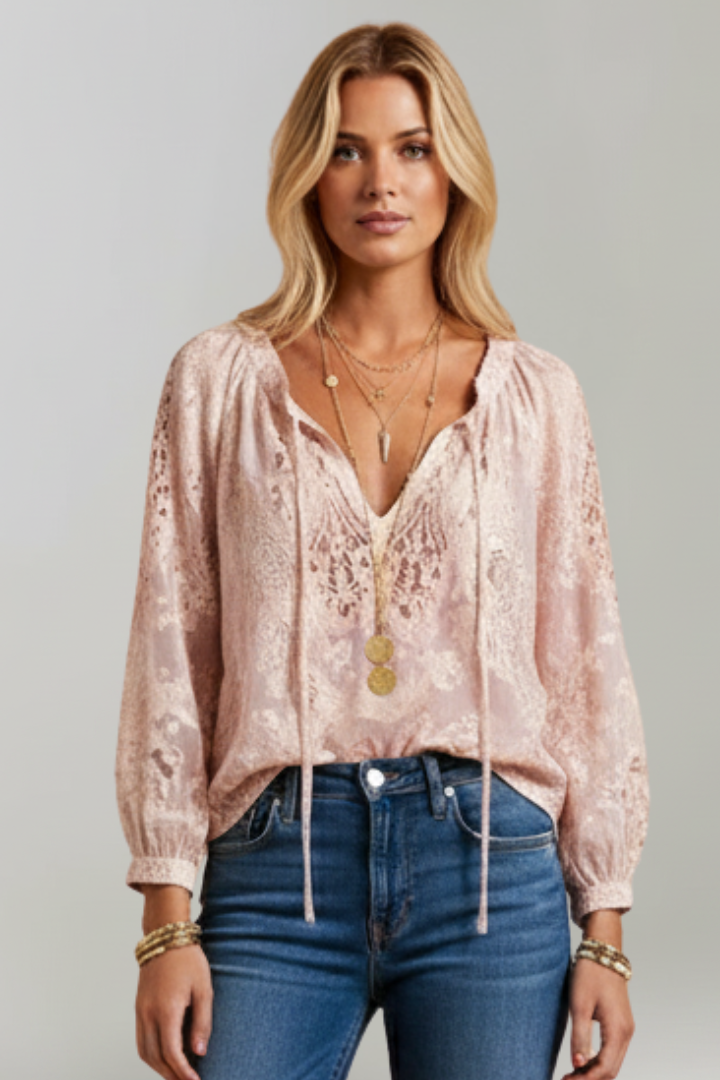 Pink lace blouse with tied neckline, V-shaped yoke, long puff sleeves, and tassel ties