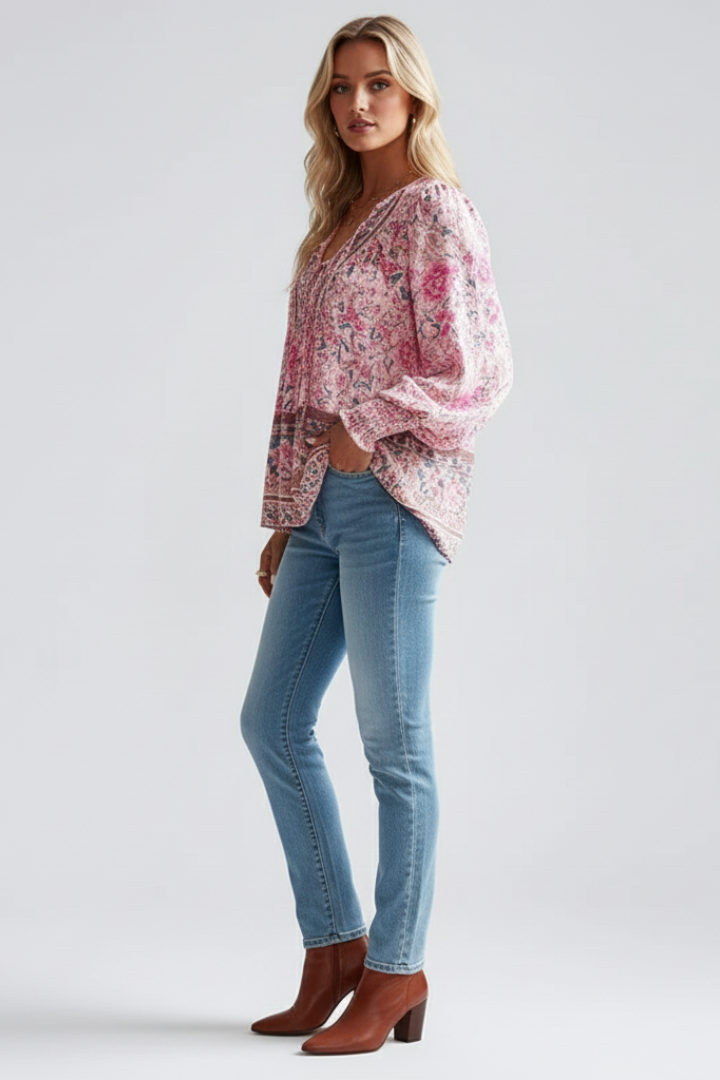 Pink floral long-sleeve blouse with V-neck and patterned border hem