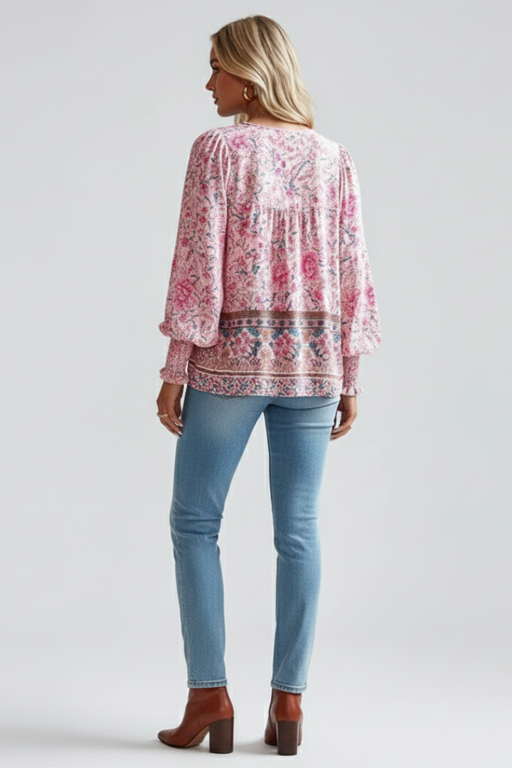 Pink floral long-sleeve blouse with buttonless back yoke and ruffled cuffs