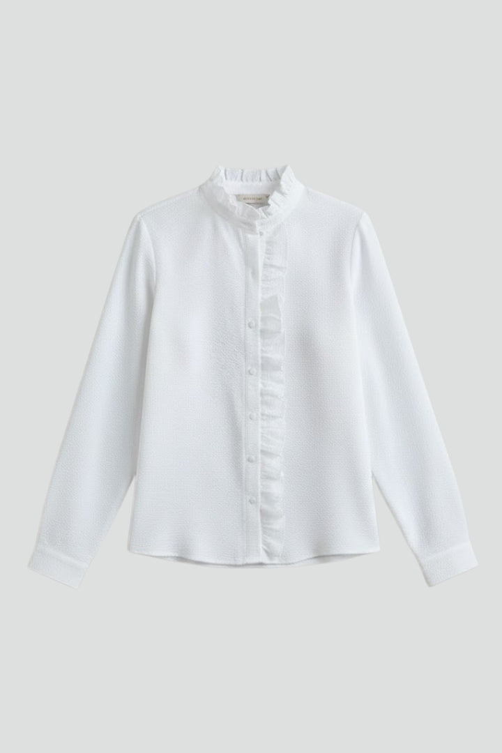 White long-sleeve blouse with ruffled placket and button front