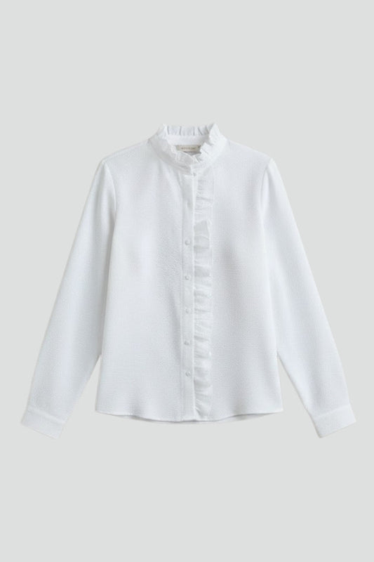 White long-sleeve blouse with ruffled placket and button front