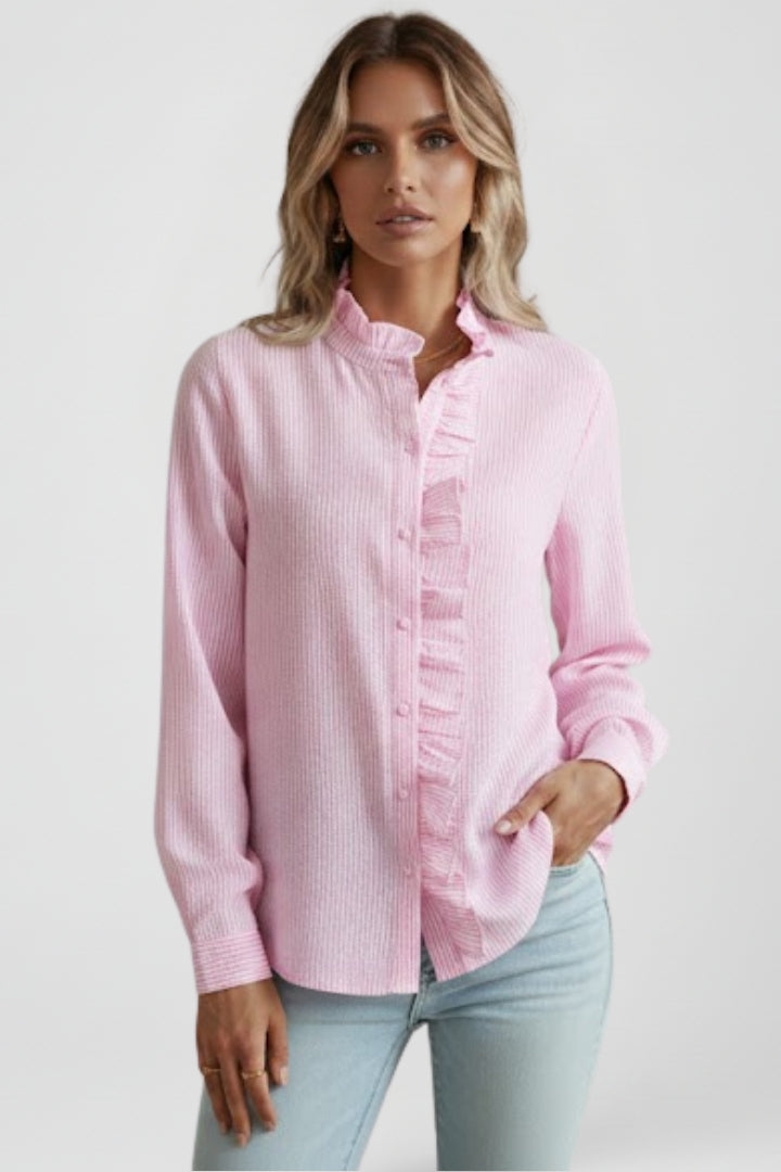 Pink long-sleeve blouse with ruffled placket and buttoned front