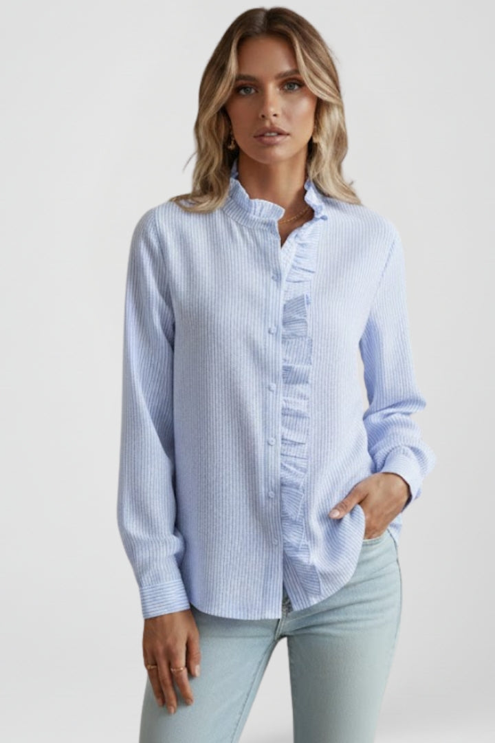 Light blue long-sleeve blouse with ruffled placket and buttoned front