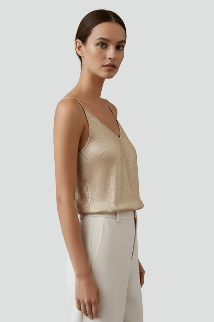 Gold thin-strap V-neck camisole top shown from the side, with spaghetti straps
