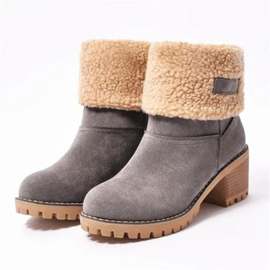 Gray mid-calf lug sole boots with tan sherpa cuff and block heel.