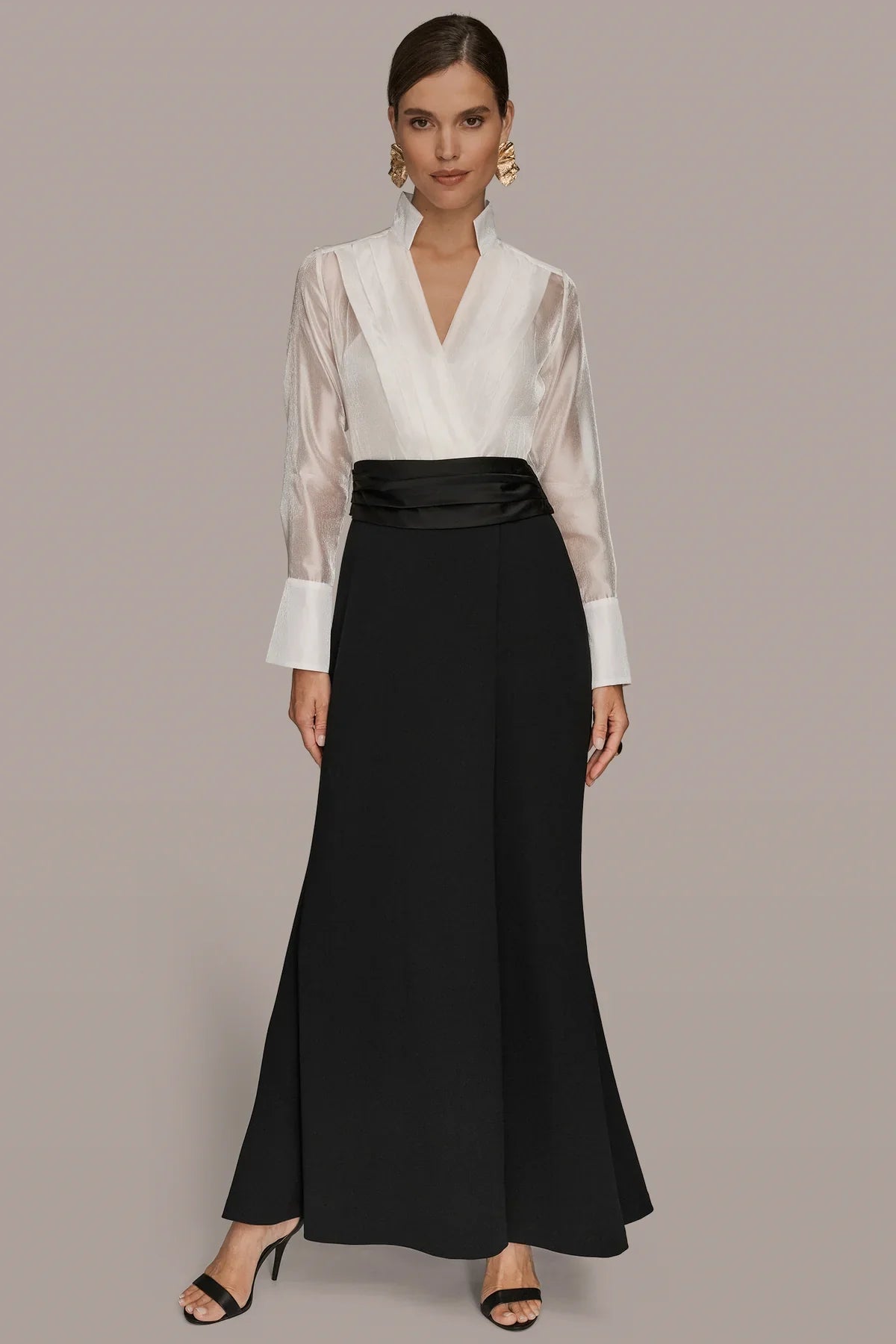 Wrap tuxedo gown: cream high-collar wrap top, black belted long skirt.
