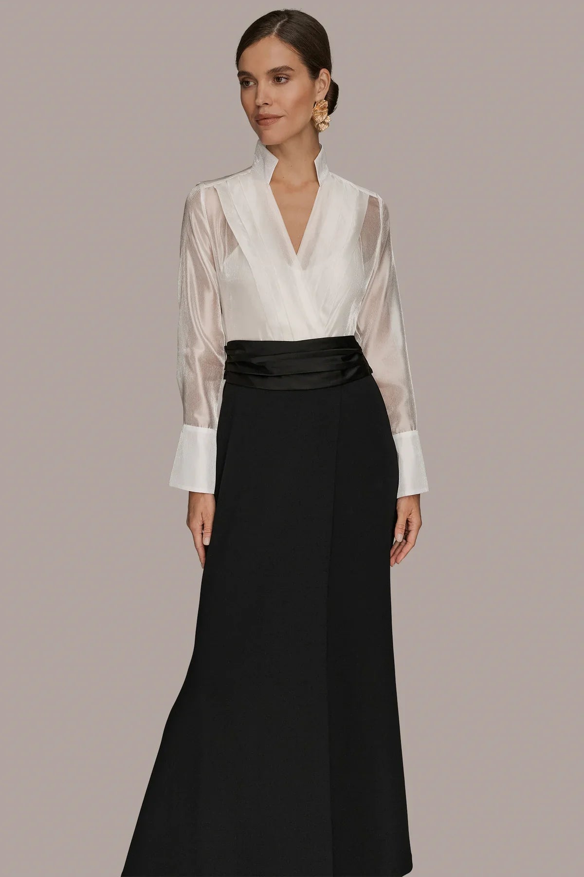 Tuxedo wrap gown front: cream V-neck wrap bodice with high collar and black long skirt.